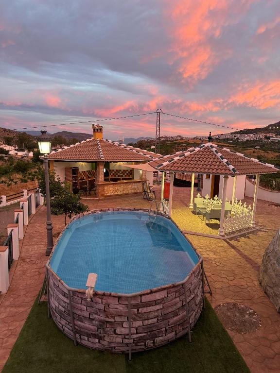 a swimming pool in a yard with a house at Casa en Villa Romero in Alora