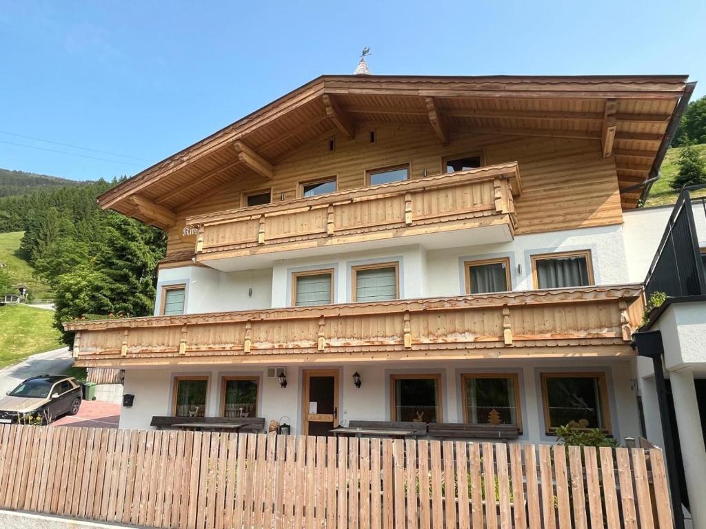 a house with a wooden fence in front of it at Chalet Kirsten in Zell am See