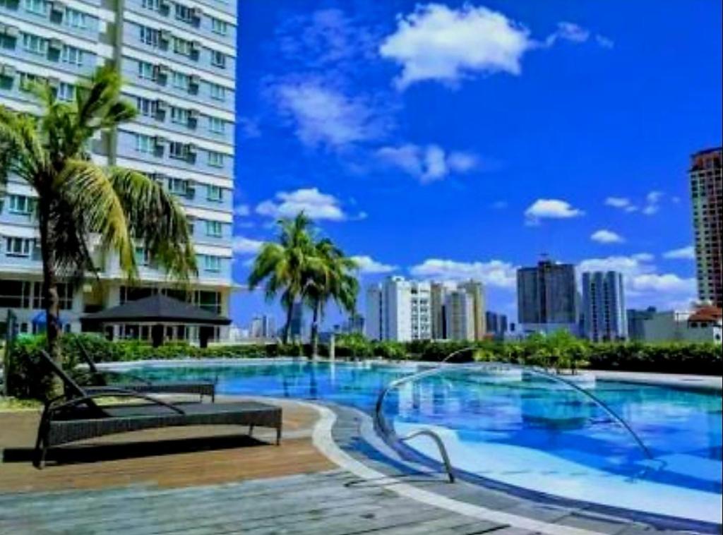 a large swimming pool in the middle of a city at My Quiet Place at The Beacon - Makati City in Manila