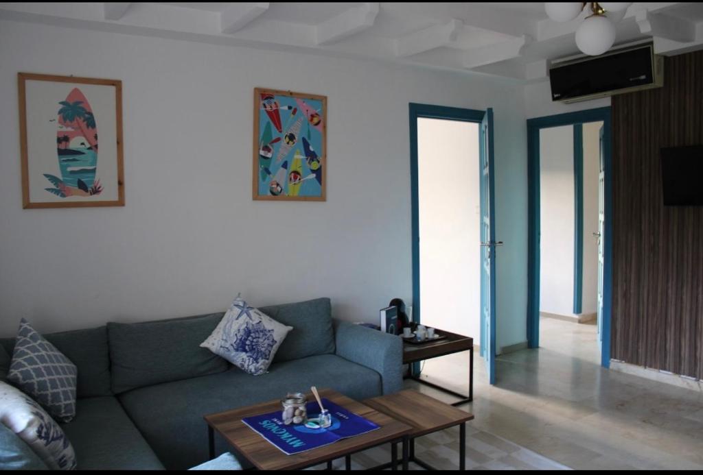 a living room with a couch and a table at K Playa Vibe Darbouazza in Dar Bouazza