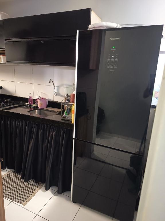 a black microwave oven in a kitchen next to a counter at ApartamentoA306 in Ananindeua