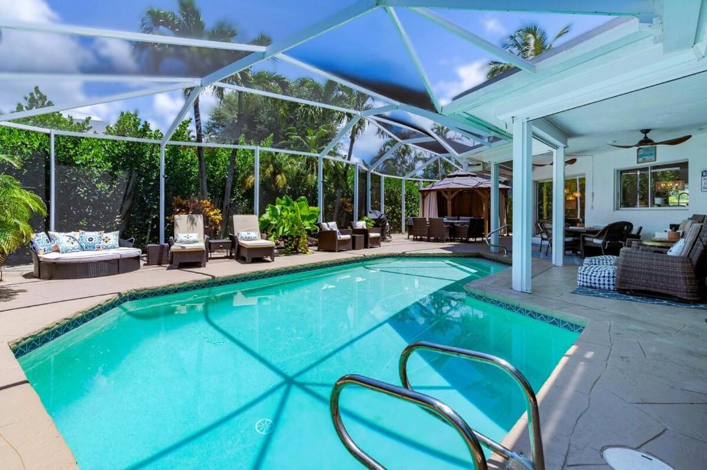 a swimming pool in a house with an outdoor patio at Dream Tropical Oasis 10 mins Walking to the Beach in Marco Island
