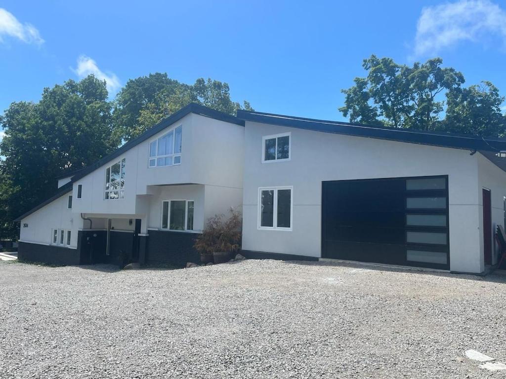 a large white building with a large garage at Country Elegance Near GTA in Schomberg