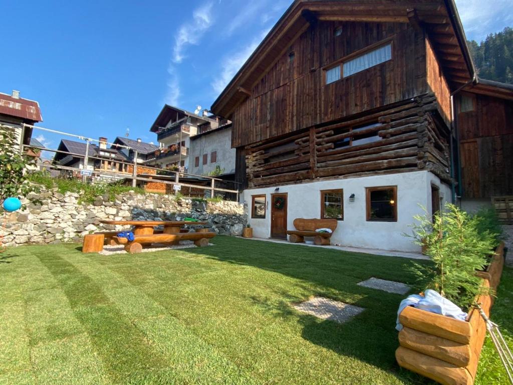 a house with a large yard with a building at Chalet le Dolomiti in Borca di Cadore