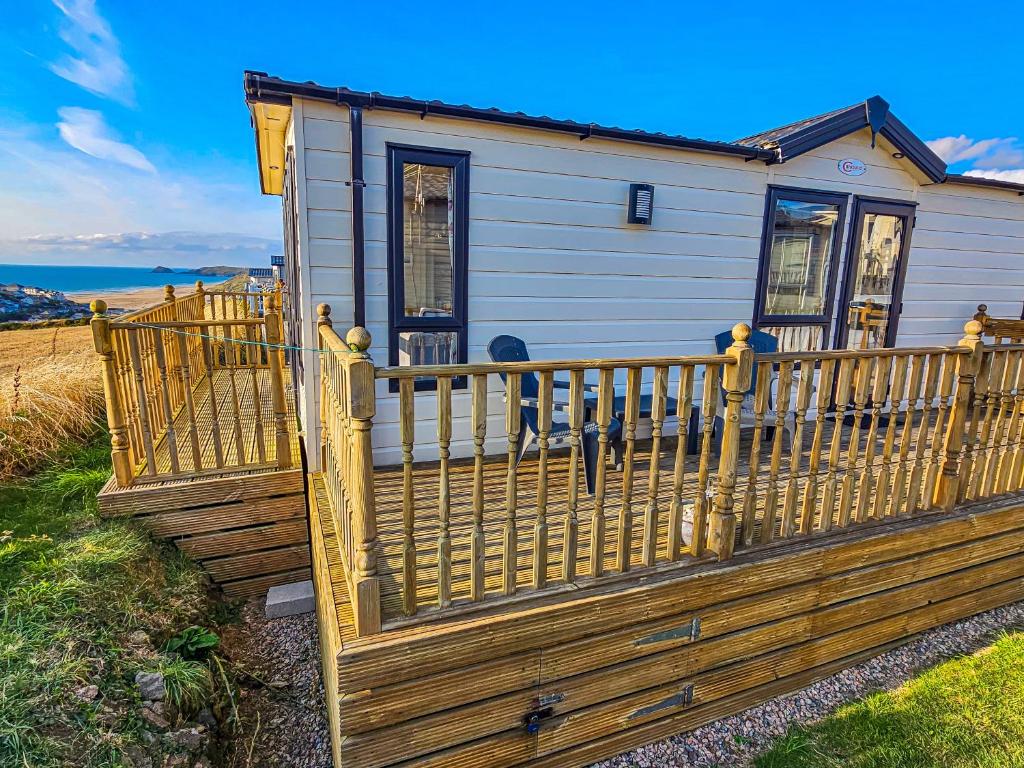 a house with a wooden fence in front of it at Sea views at Serenity! in Truro