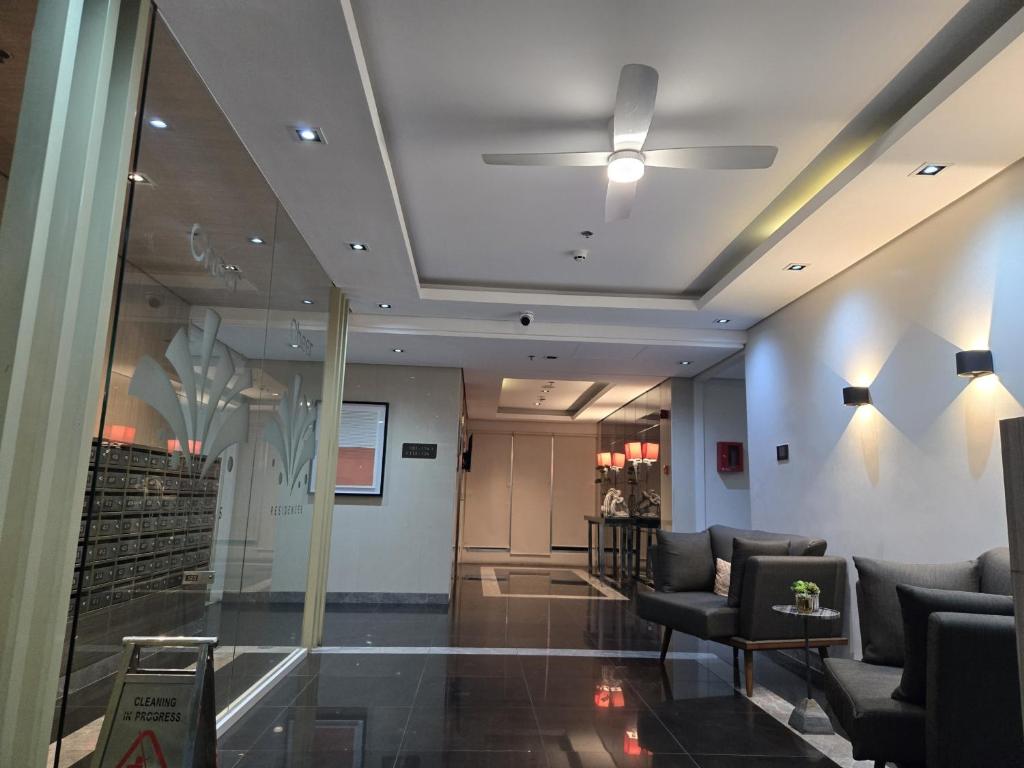 a lobby with chairs and a ceiling at 2 Bedroom Suite in SM Marilao - Cheer Residence in Marilao