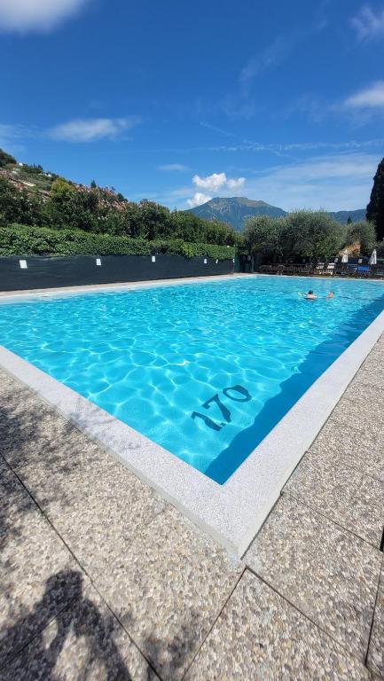 a blue swimming pool with the word ash on it at appartamento SUNLIGHT in Riva del Garda