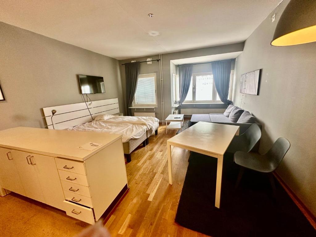 Habitación pequeña con 1 cama, escritorio y 1 dormitorio. en Skarholmen Stockholm Apartment, en Estocolmo