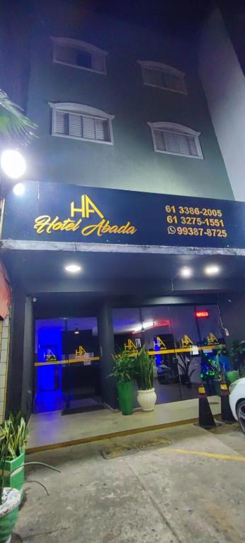 a store front with a blue and yellow sign on it at Hotel Abada in Brasília