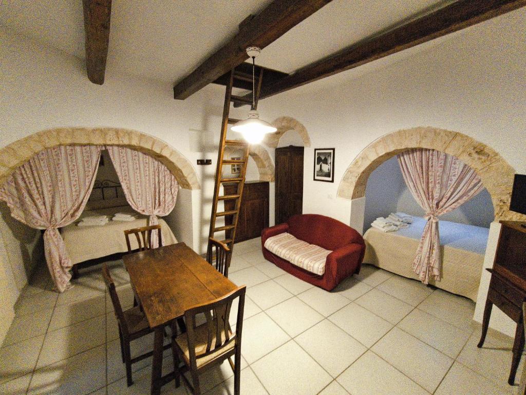 a bedroom with a bed and a table and chairs at Da Nonna Filomena in Alberobello
