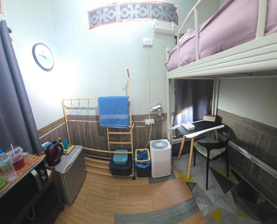 a room with a bed and a desk and a chair at 113 Olan Place Cozy Loft Apartment with free Wi-fi in Bangkok