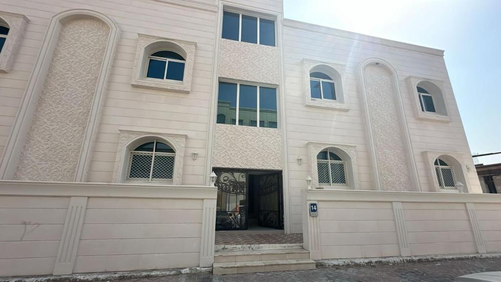 a large white house with a garage at River & Sky Homes 6004 in Abu Dhabi