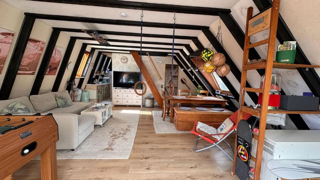 a living room with a loft bed and a couch at Gemütliches Ferienhaus in der Eifel mit Pool, Tennisplatz, Minigolf und nahem See in Blankenheim