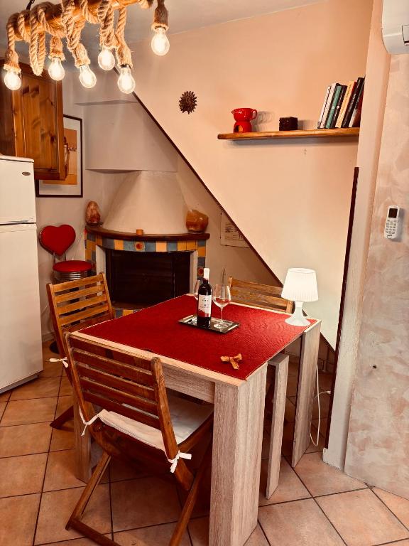 a kitchen with a table with a bottle of wine on it at La casetta di Nonna Rosa in Santa Domenica
