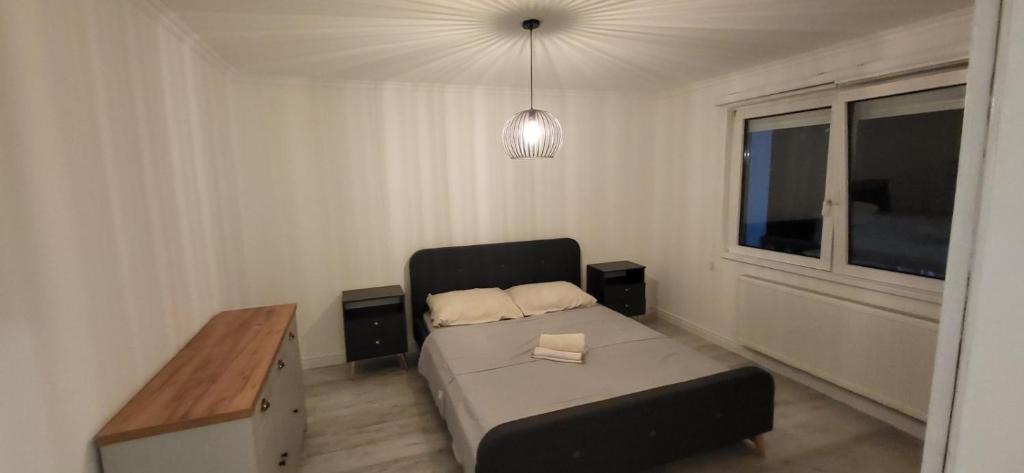 a bedroom with a bed and a desk and a window at Apartman Lala in Sarajevo