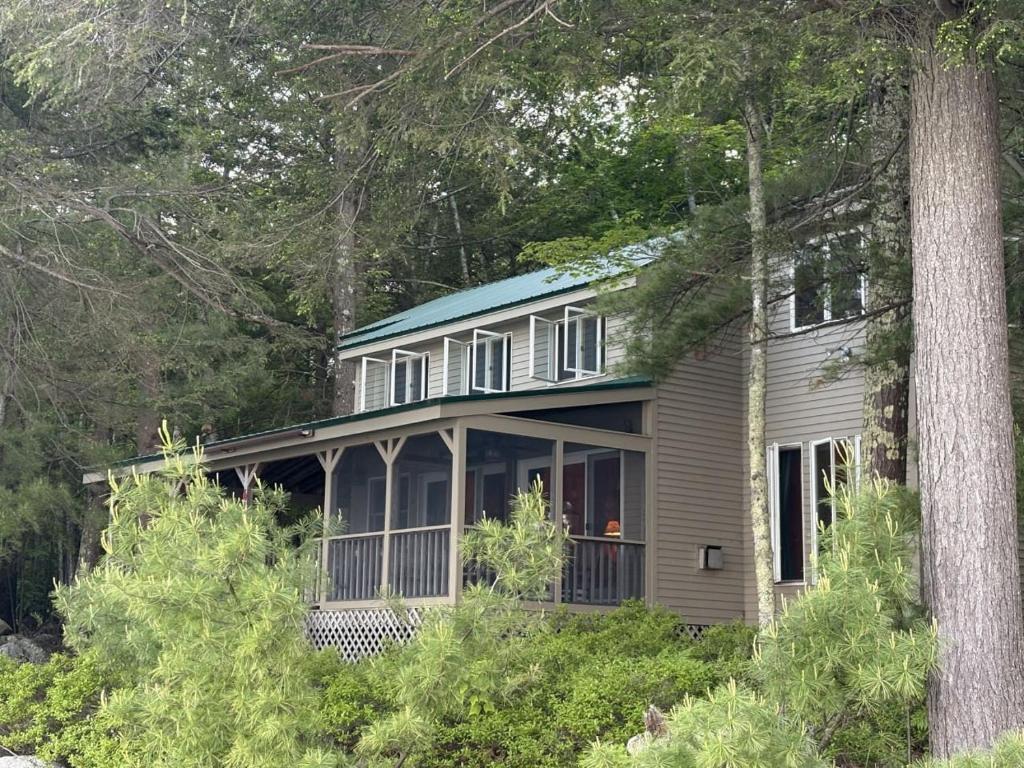 a house in the woods with trees at Sandy Beach, Private Dock & Boat Access in Meredith