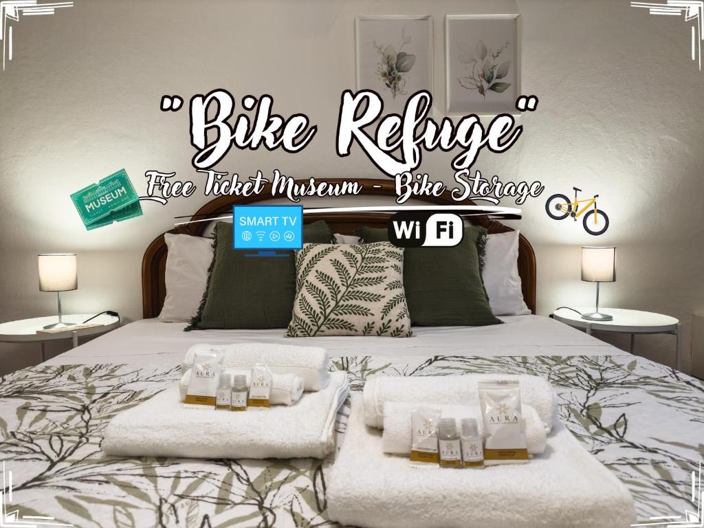 a bed with a sign that reads bike refuge fire watch mountain bike share at Bike Refuge - WiFi - Free Ticket Museum - Smart TV in Altare