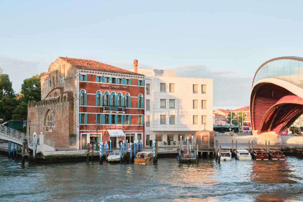 a group of buildings and boats on a river at Hotel Santa Chiara in Venice