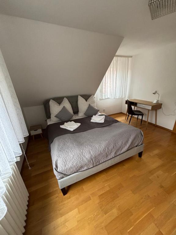 a bedroom with a bed and a desk and a table at Murgtal Traum Apartment Schwarzwald in Baiersbronn