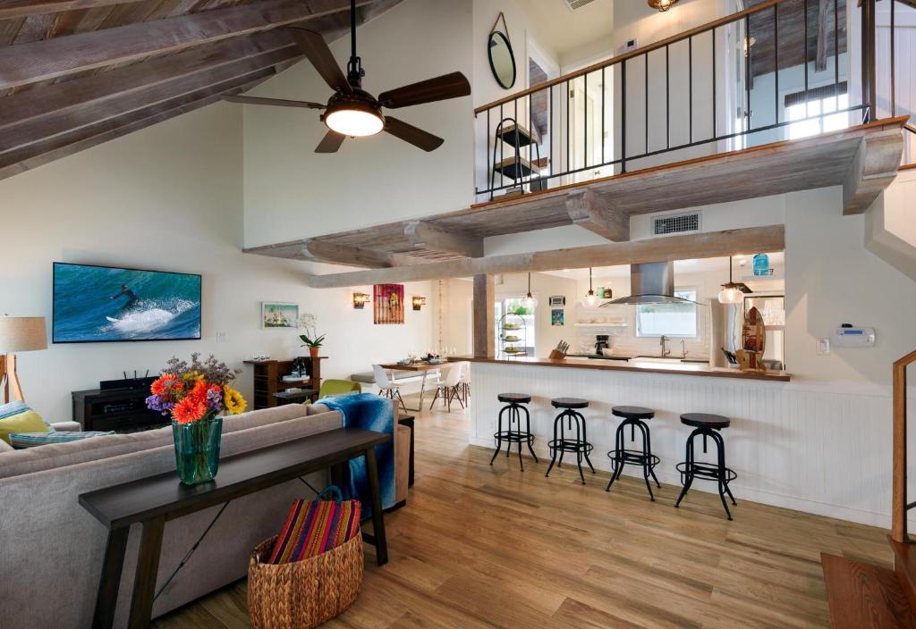 an open living room with a couch and a table at Sea La Vie by Paradise Retreats in Ventura