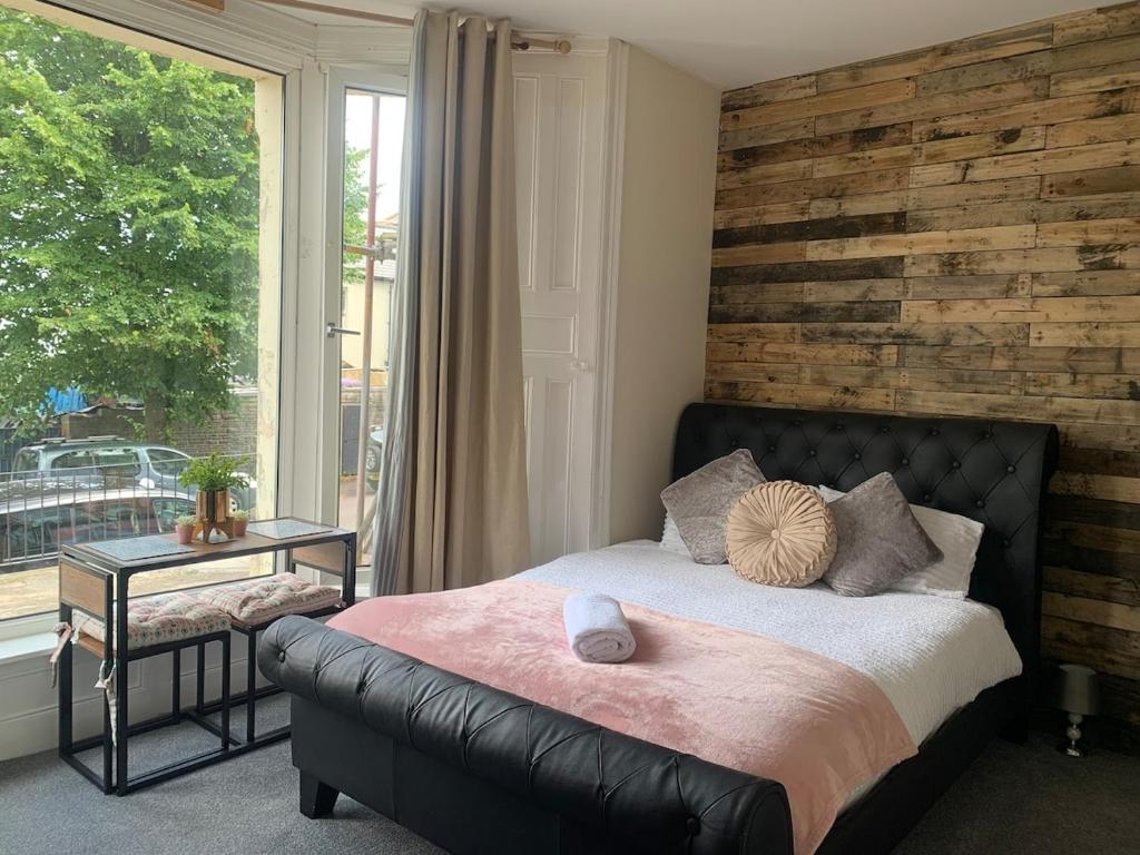 a bedroom with a bed and a large window at 155 Studio 1 - Uplands in Swansea