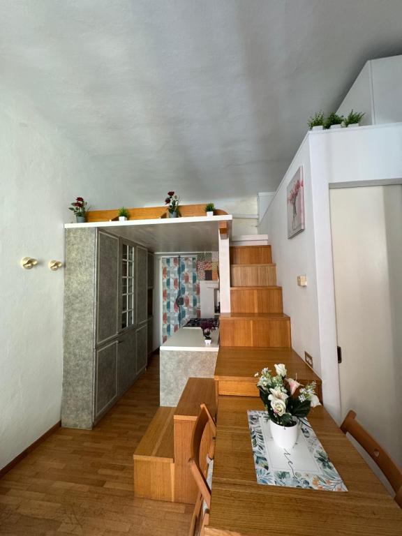 a room with stairs and a table with flowers on it at Cozy Escape Porta Romana in Milan