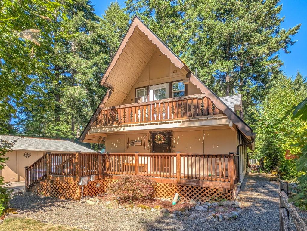 a large house with a deck and trees at Coal Creek Chalet | Creek, AC, Pet Friendly in Packwood