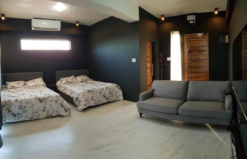 a living room with two beds and a couch at Bethany Hill Resort And Restaurant in Almeria