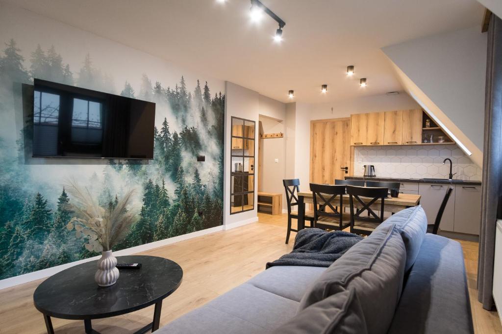 a living room with a couch and a table at Willa Jodełka in Zakopane