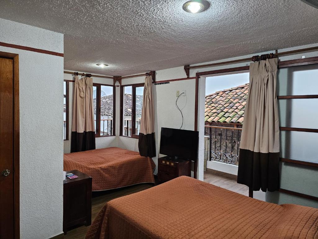 Postel nebo postele na pokoji v ubytování Posada Brisas Cuetzalan
