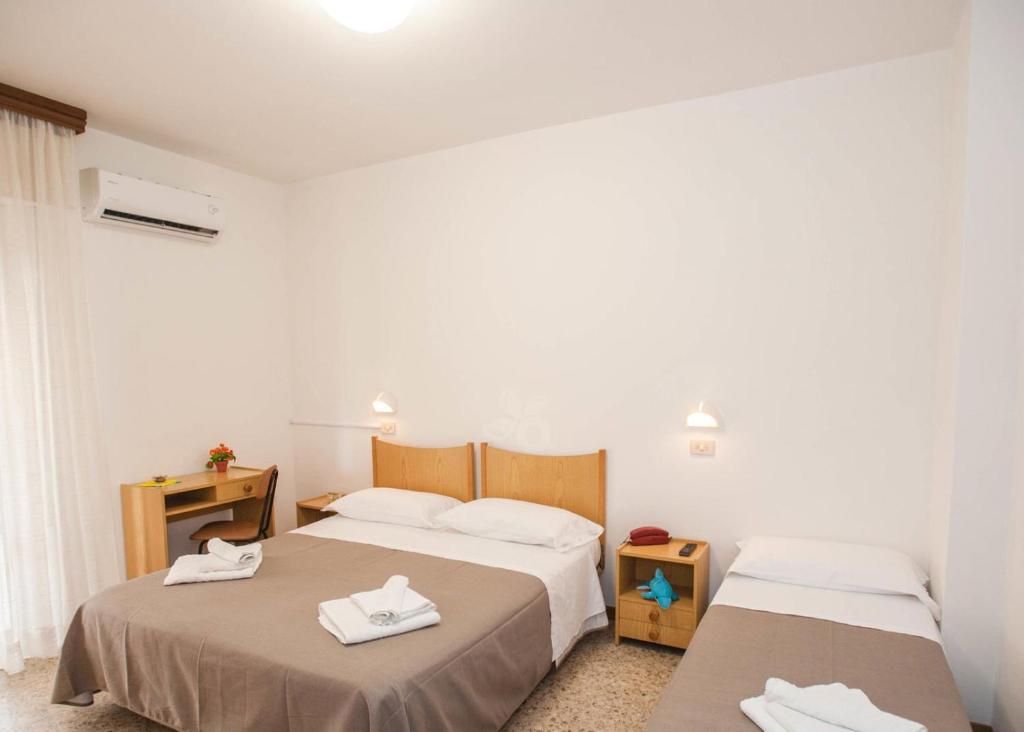 Postel nebo postele na pokoji v ubytování Hotel Massimo