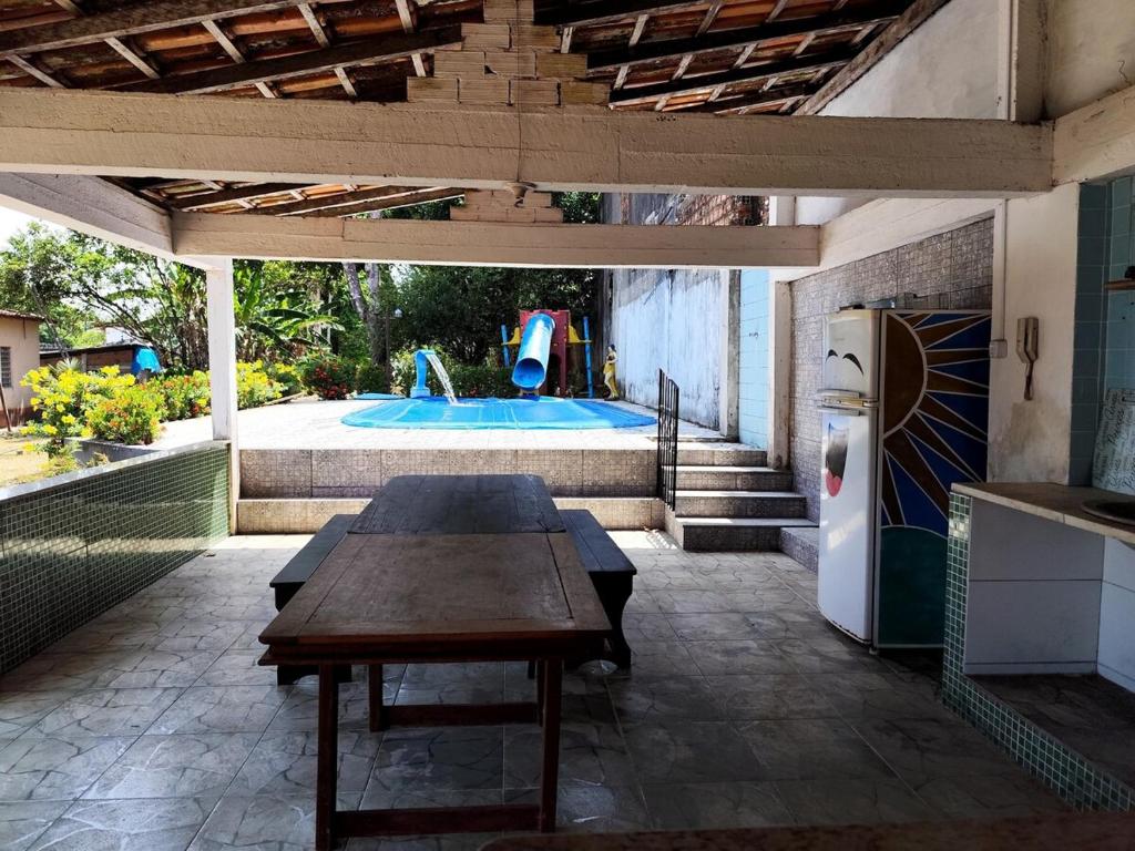 a patio with a table and a swimming pool at COP 30 Mosqueiro Castle in Belém