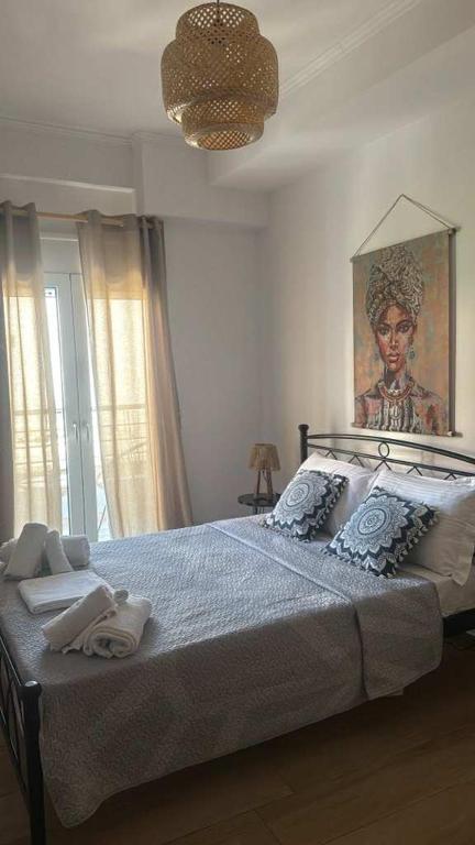 a bedroom with a large bed with a painting on the wall at Kalisti Apartment in Lixouri