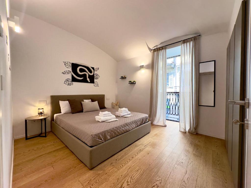a bedroom with a bed and a large window at Alfieri 7 Luxury Suite - Centro Torino in Turin