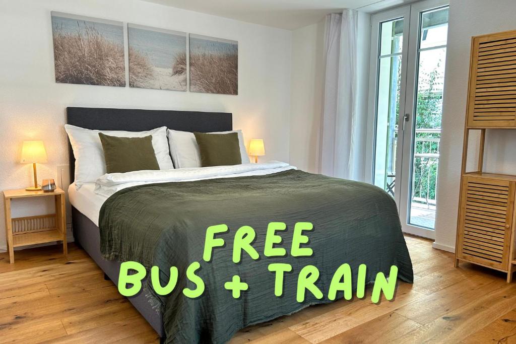 a bedroom with a bed with a free bus train sign on it at Klara 1011 - Olma, Spital, Uni St- Gallen in St. Gallen