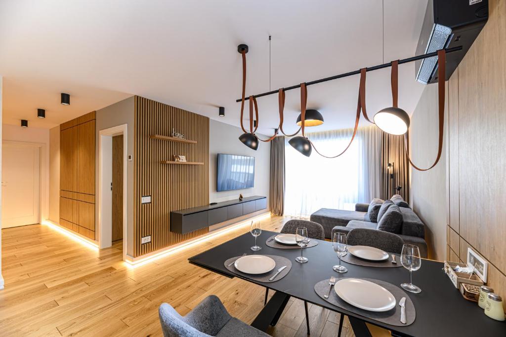 a living room with a table and a couch at B-Holiday Luxury Apartments Urban Plaza in Braşov