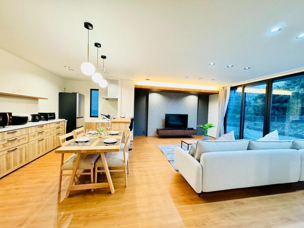 a living room with a white couch and a table at Akikawa Villas 9 - Vacation STAY 18842 in Yuge