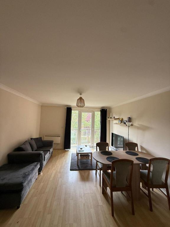 a living room with a table and a couch at 2 Bedroom by JL Airport & Retail in Liverpool