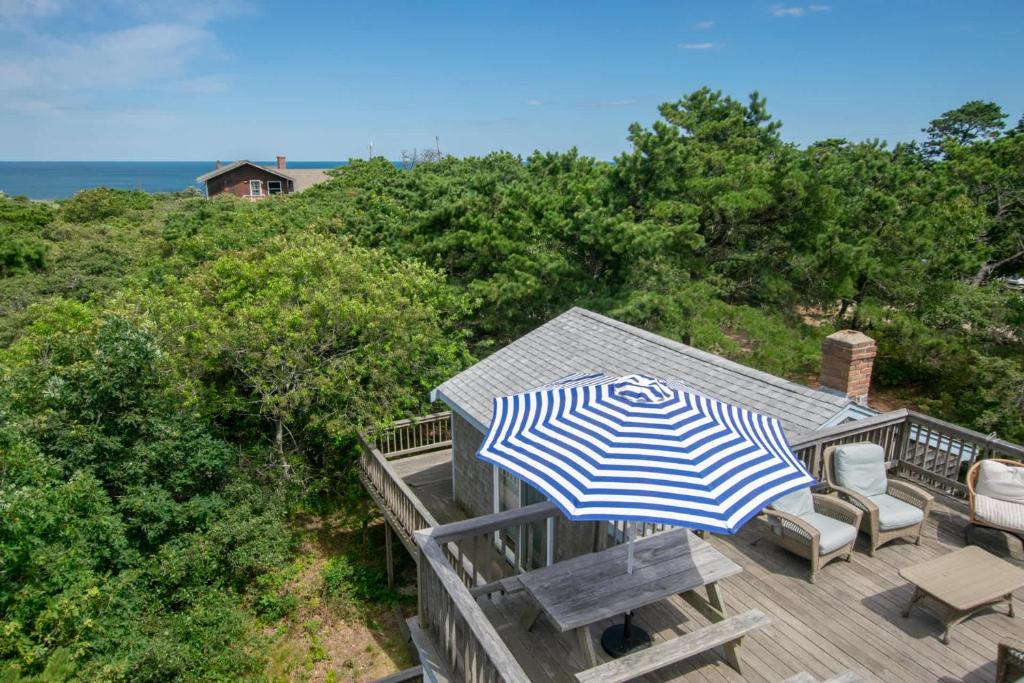 a blue and white umbrella sitting on a deck at Walk to Oceanside Beach in Wellfleet