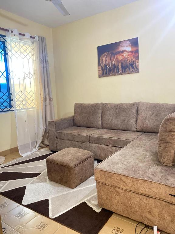 a living room with a couch and a table at SuNRISE LUXURY HOMES in Mtwapa