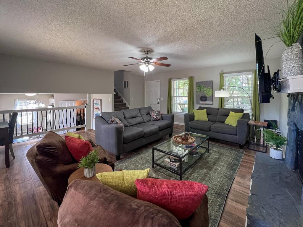 a living room with couches and a ceiling fan at New! 10 Guest! King Bed! Patio! Grill! Near ATL & Downtown Norcross in Norcross