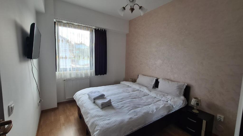 a bedroom with a large white bed in a room at Perfect Stay in Sibiu