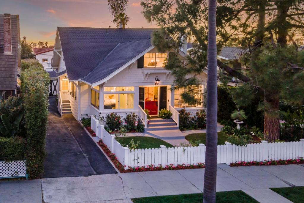 a white house with a white fence at The Sea Captains House & Loft by Paradise Retreats in Santa Barbara