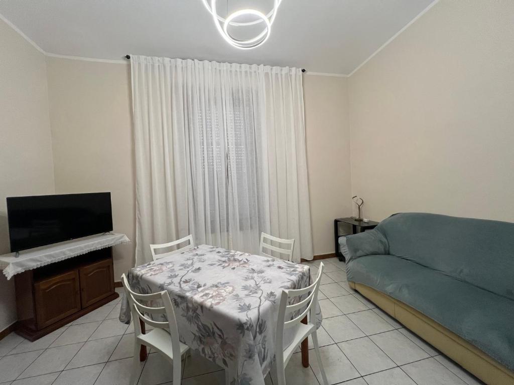a bedroom with a table and a bed and a television at Apartment in Alexandria! in Alessandria