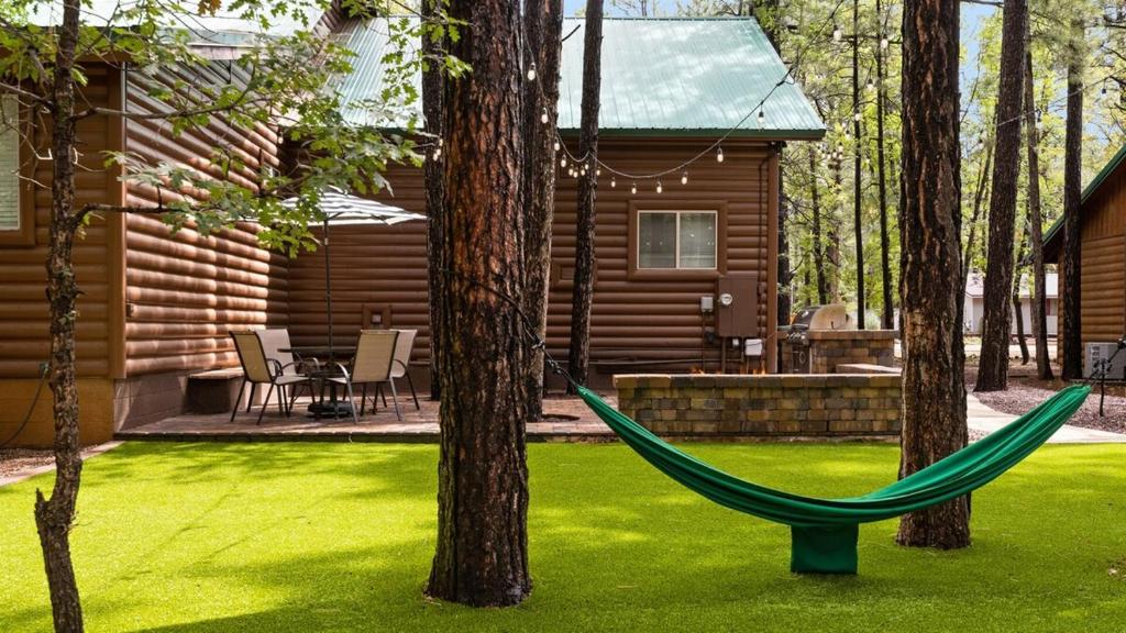 a hammock in the yard of a log cabin at Summer Special-Pinetop Cabin-Great 4 Family in Pinetop-Lakeside