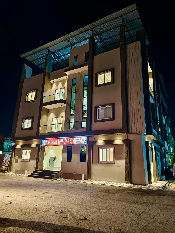 a large building with lights on in the night at HOTEL HERITAGE Inn in Indore