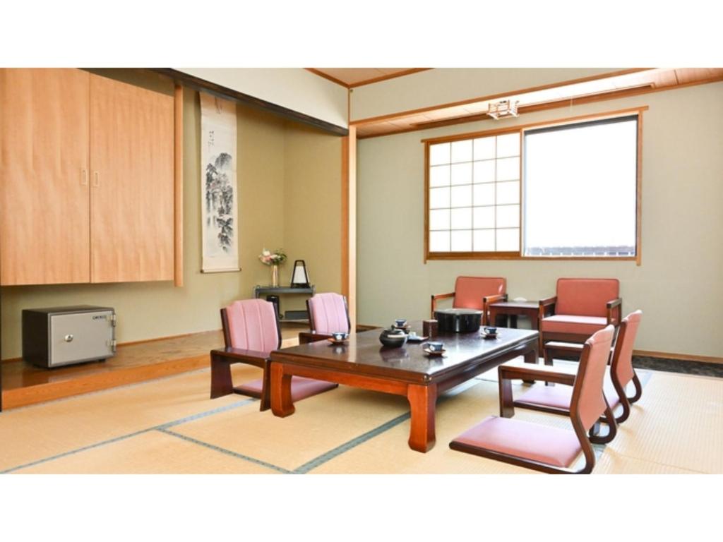 a conference room with a table and chairs and a window at Komakusa Hotel - Vacation STAY 03227v in Matsumoto