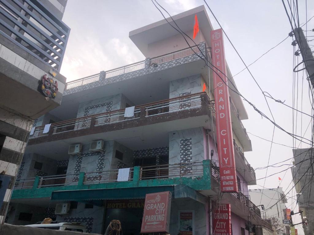 a tall building with signs on the side of it at Hotel O Grand City in Chandīgarh