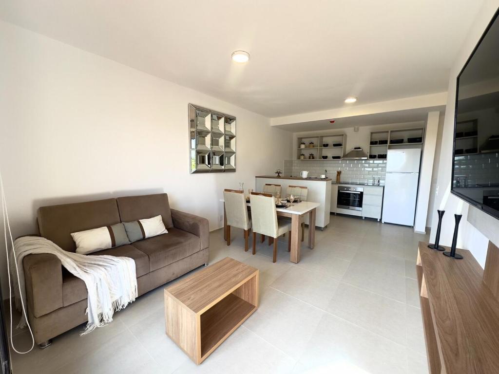 a living room with a couch and a table at Apartamento nuevo de 2 habitaciones cerca de Asunción 212 in Luque