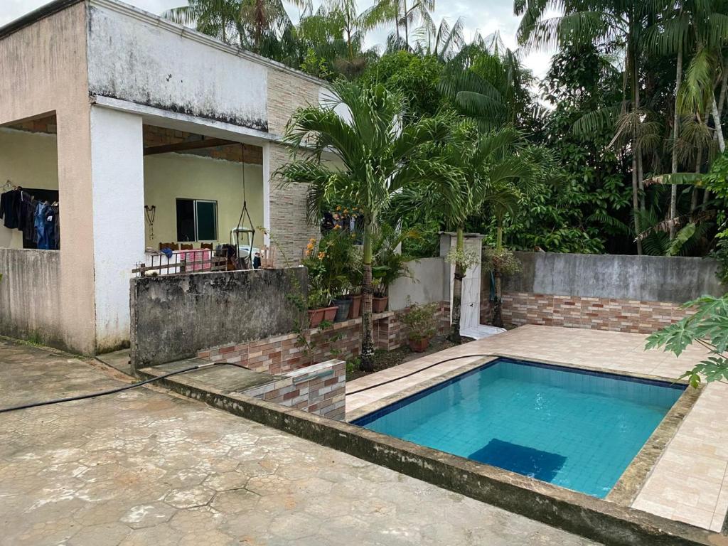 a house with a swimming pool in front of it at Casa para COP30 in Ananindeua